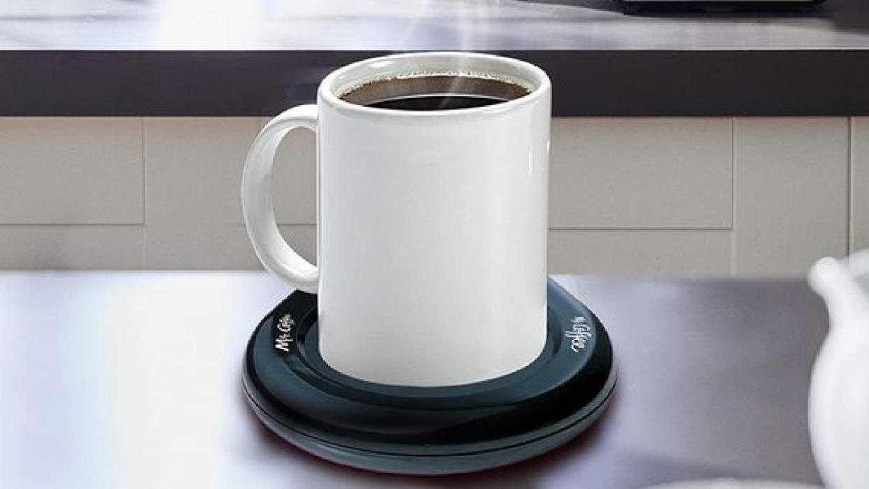  A coffee cup on a "Mr Coffee" USB mug warmer. 