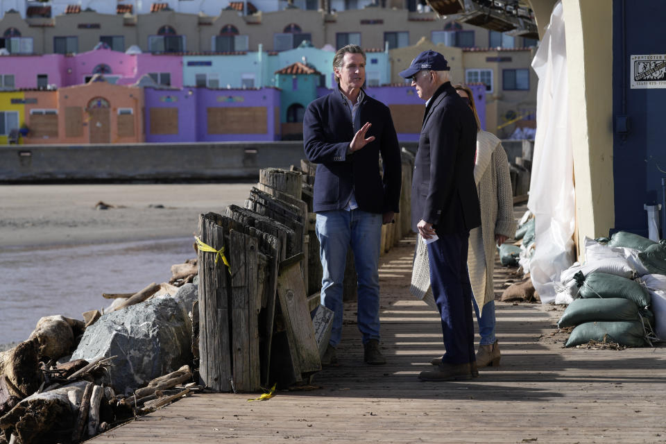 President Joe Biden talks on the boardwalk with California Gov. Gavin Newsom as he visitswith business owners and local residentsin Capitola,Calif., Thursday, Jan 19, 2023,to survey recovery efforts following a series of severe storms. (AP Photo/Susan Walsh)