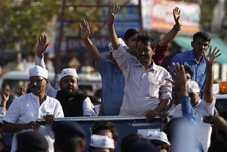 Aam Aadmi Party (AAP) chief Arvind Kejriwal (3rd R), Delhi's former chief minister, waves to supporters during a road show before the 2014 general elections in Ahmedabad March 8, 2014. REUTERS/Amit Dave