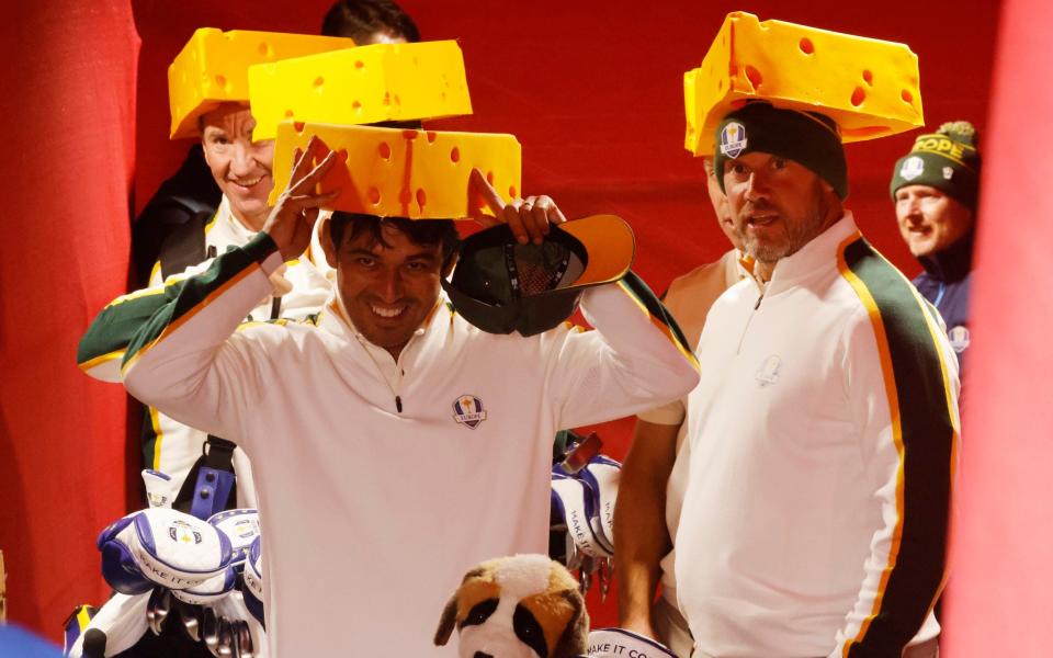 Lee Westwood (right) wears his cheese hat with pride - REUTERS