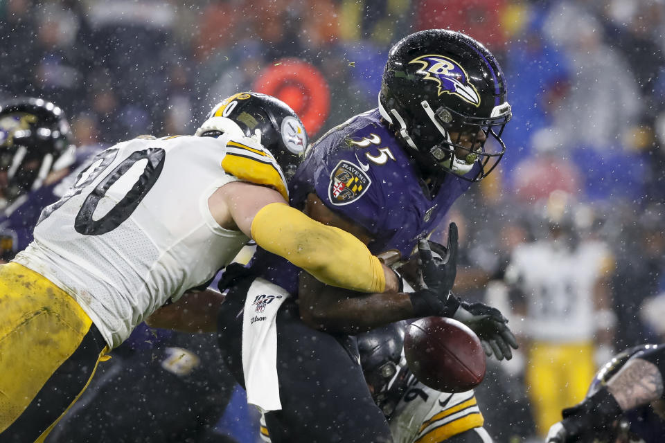 T.J. Watt of the Pittsburgh Steelers causes Gus Edwards of the Baltimore Ravens to fumble in a game last season. (Photo by Scott Taetsch/Getty Images)