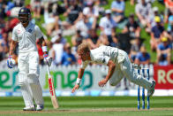 Neil Wagner of New Zealand loses his footing while bowling as Virat Kohli of India looks on during day two of the 2nd Test match between New Zealand and India on February 15, 2014 in Wellington, New Zealand. (Photo by Hagen Hopkins/Getty Images)