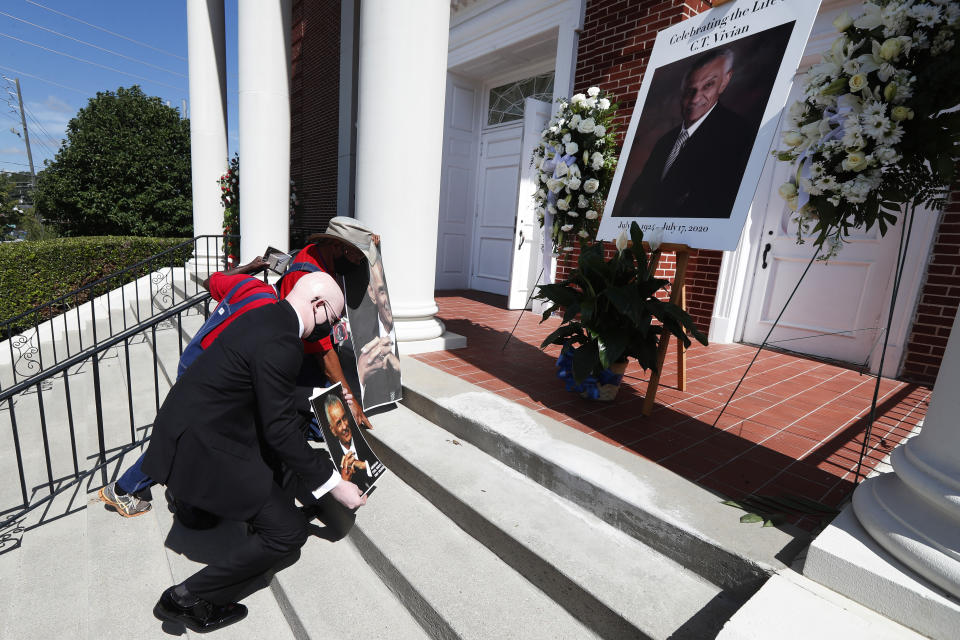 People kneel and pray outside a funeral service for Rev. C.T. Vivian Thursday, July 23, 2020, in Atlanta. (AP Photo/John Bazemore)