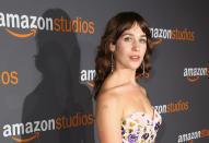 <p>Lola Kirke showed her disdain for Paul Ryan with a pin that perfectly matched her Andrew Gn dress at the Globes. (Photo: Getty Images) </p>