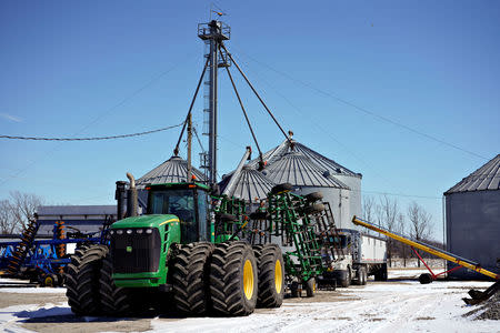 Farm equipment and grain storage belonging to farmer Austin Rincker sit outside in Moweaqua, Illinois, U.S., March 6, 2019. Rincker will farm approximately 2500 acres in the upcoming season, split evenly between corn and soybeans. Picture taken March 6, 2019. REUTERS/Daniel Acker