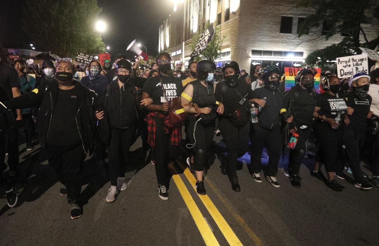 Demonstrators march on Monroe Avenue in downtown Rochester to protest the police and what they called the murder of Daniel Prude.