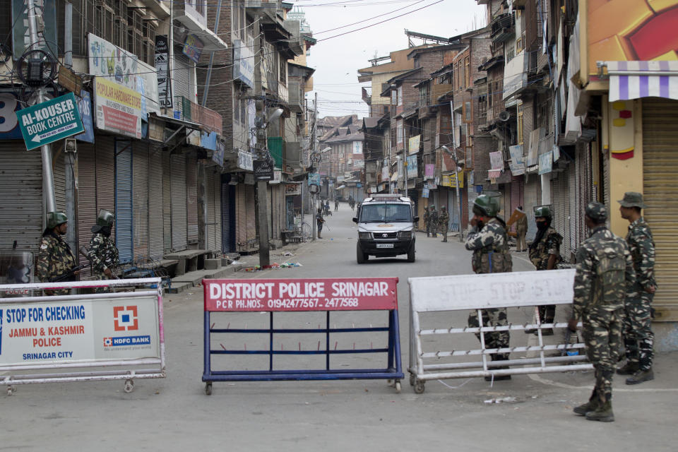 In this Tuesday, Aug. 6, 2019 photo, Indian paramilitary soldiers stand guard during curfew in Srinagar, Indian controlled Kashmir. The lives of millions in India's only Muslim-majority region have been upended since the latest — and most serious — crackdown followed a decision by New Delhi to revoke the special status of Jammu and Kashmir and downgrade the Himalayan region from statehood to a territory. Kashmir is claimed in full by both India and Pakistan, and rebels have been fighting Indian rule in the portion it administers for decades. (AP Photo/Dar Yasin)