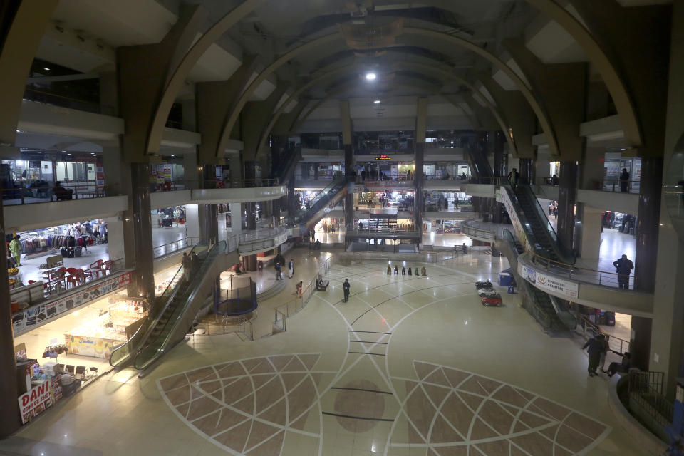 People visit a shopping mall in Peshawar, Pakistan, Wednesday, Jan. 4, 2023. Authorities on Wednesday ordered shopping malls and markets to close by 8:30 p.m. as part of a new energy conservation plan aimed at easing Pakistan's economic crisis, officials said. The move comes amid talks with the International Monetary Fund. (AP Photo/Muhammad Sajjad)