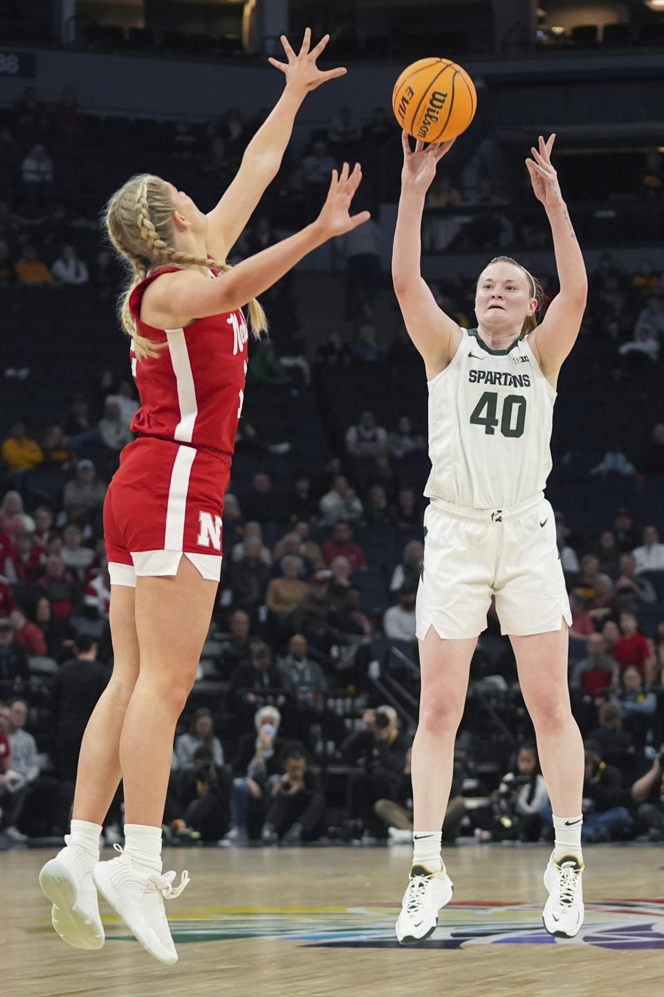 Michigan State guard Julia Ayrault (40) shoots over Nebraska forward Jessica Petrie during the second half of an NCAA college basketball quarterfinal game at the Big Ten women's tournament Friday, March 8, 2024, in Minneapolis. (AP Photo/Abbie Parr)