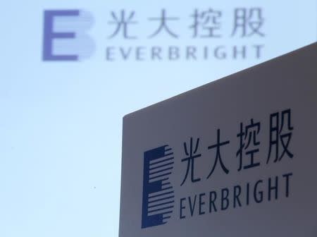 FILE PHOTO: The company logos of China Everbright International are displayed at a news conference on the company's annual results in Hong Kong, China March 23, 2016. REUTERS/Bobby Yip/File Photo