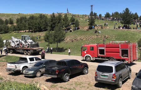 A fire engine drives as damaged vehicles that belonged to Kurdish fighters from the People's Protection Units (YPG) are transported from their headquarters after it was hit by Turkish airstrikes in Mount Karachok near Malikiya, Syria April 25, 2017. REUTERS/Rodi Said