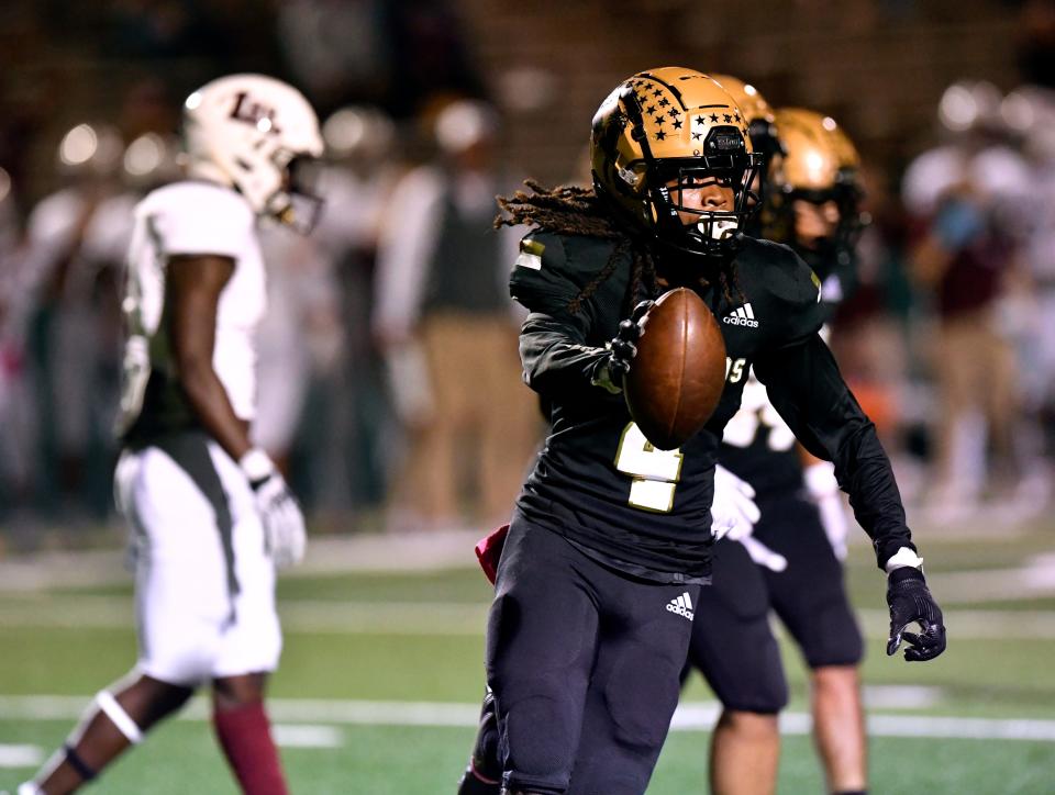 Eagles defensive back Kwame Collins runs back to the Abilene High bench after forcing a turnover against Midland Legacy on Oct. 1.