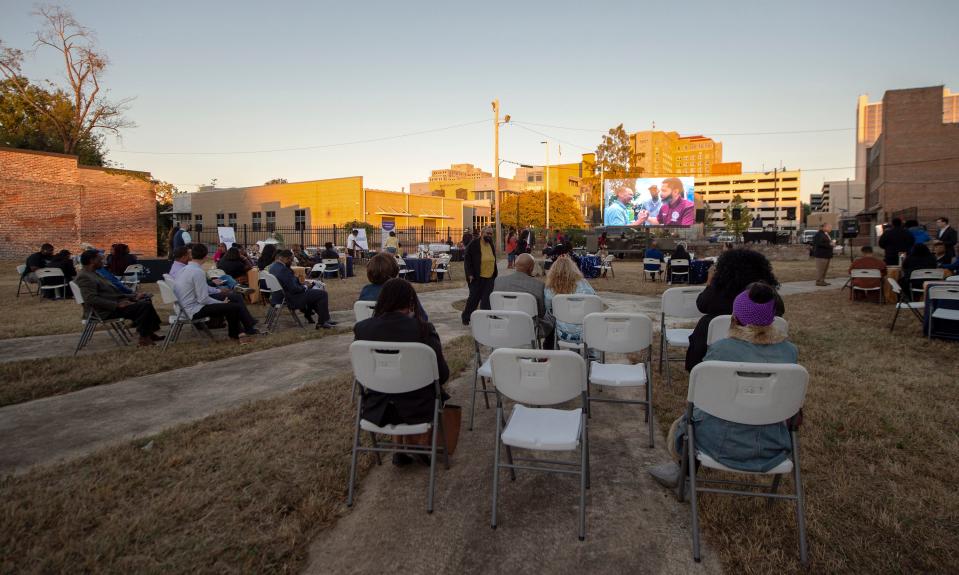 People wait for the start of the State of the City address by Jackson Mayor Chokwe Antar Lumumba at the Farish Street Courtyard in Jackson, Miss., Thursday, Oct. 27, 2022. The address was prerecorded and shown on a screen. The mayor took the podium for comments afterward.