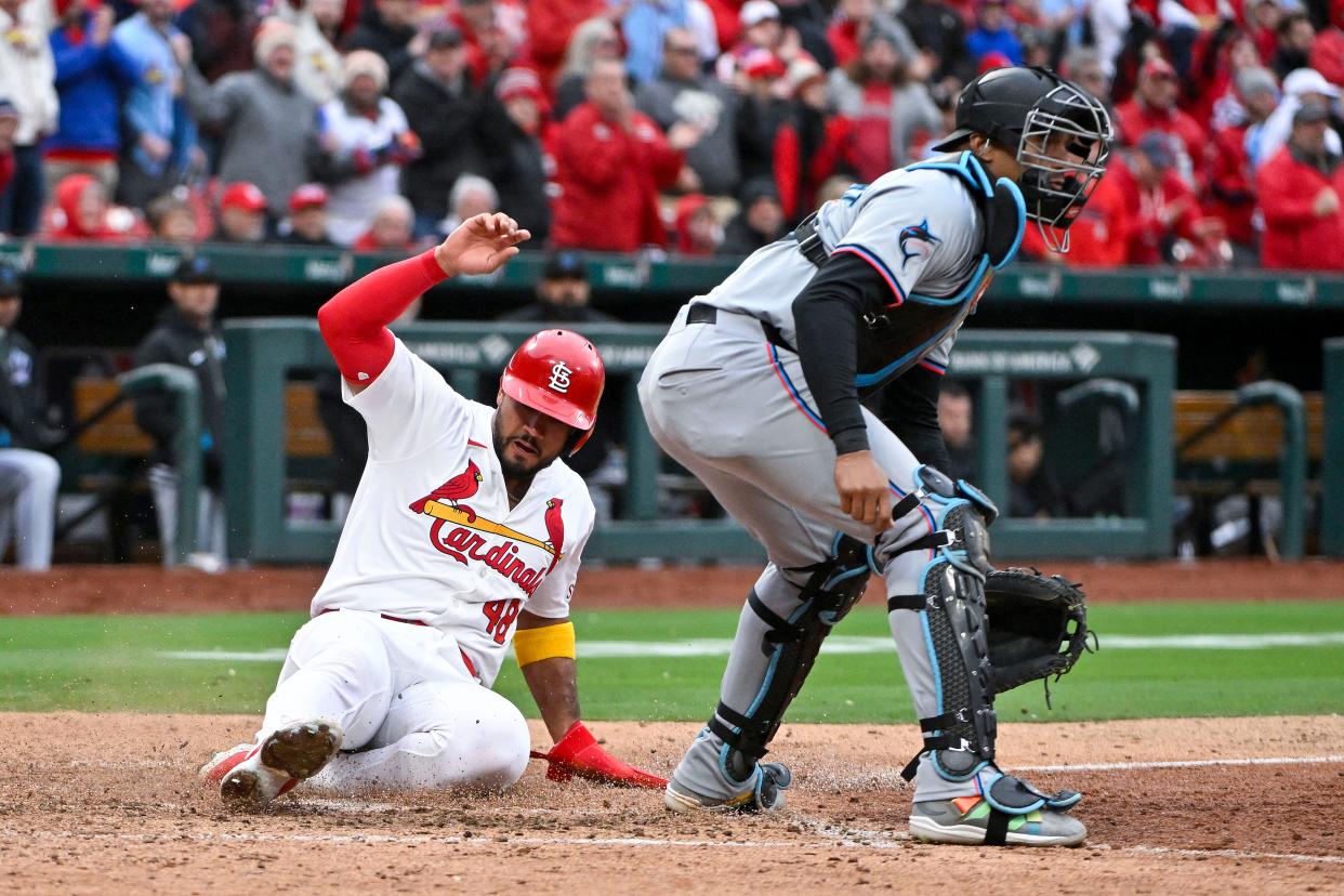 Apr 4, 2024; St. Louis, Missouri, USA; St. Louis Cardinals catcher Ivan Herrera (48) slides safely past Miami Marlins catcher Christian Bethancourt (25) during the seventh inning at Busch Stadium. Mandatory Credit: Jeff Curry-USA TODAY Sports