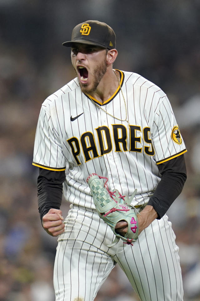 Former San Diego Padres pitcher Jake Peavy, left, reacts as he is