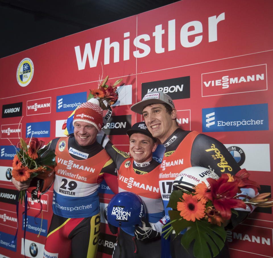 Winner Wolfgang Kindl, center, of Austria, is flanked by second-place Felix Loch, left, of Germany, and third-place Reinhard Egger, right, at the World Cup men’s luge event in Whistler, British Columbia, Friday, Nov. 30, 2018. (Darryl Dyck/The Canadian Press via AP)