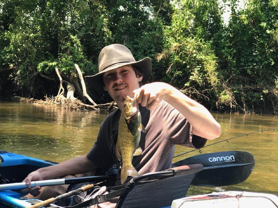 Bryson Parcell shows off a fish he caught.