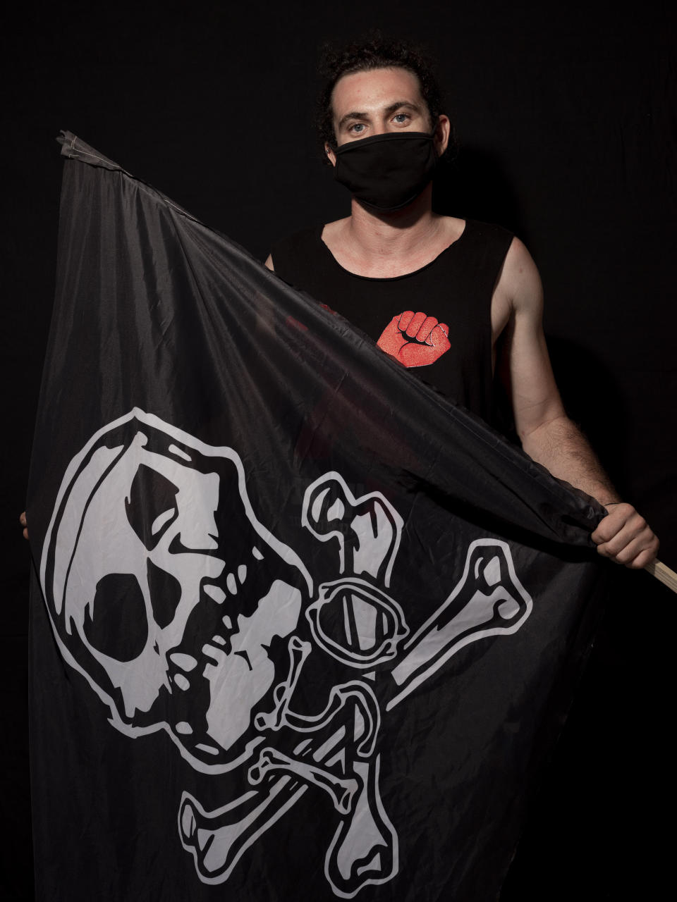 Daniel Shama, 25, poses for a photo during a protest against Israel's Prime Minister Benjamin Netanyahu, outside his residence in Jerusalem, Thursday, July 23, 2020. The wave of colorful and combative demonstrations against Netanyahu and his perceived failure to handle the country's deepening economic crisis have been characterized by youth. With flags, facemasks, drums, placards and an assortment of props, thousands have been taking to the streets to demand change in a variety of unique ways. (AP Photo/Oded Balilty)