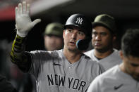 New York Yankees' Kyle Higashioka celebrates with teammates after scoring on a Harrison Bader single against the Cincinnati Reds during the ninth inning of a baseball game in Cincinnati, Friday, May 19, 2023. (AP Photo/Jeff Dean)