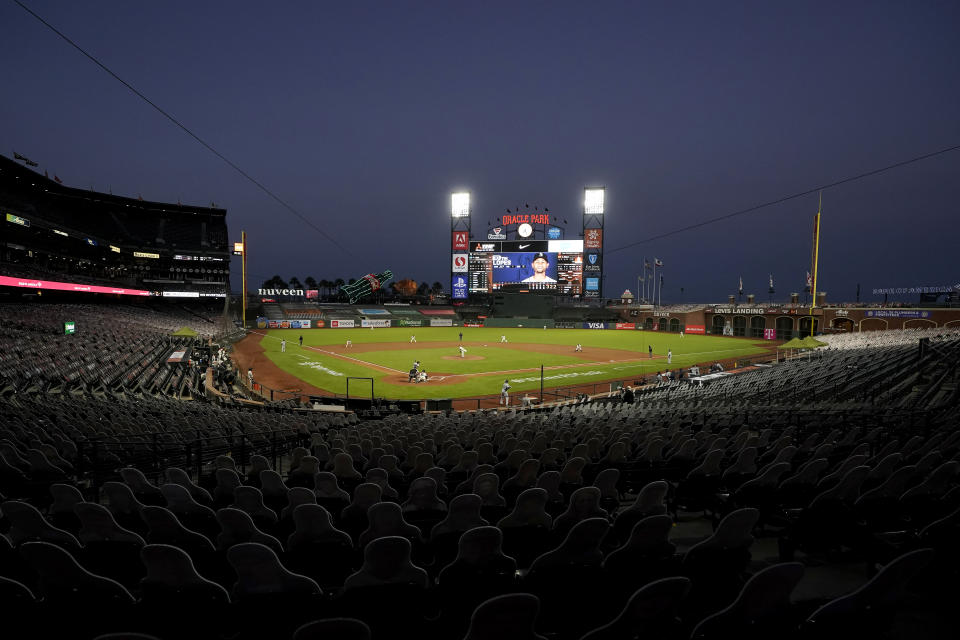 Cutouts are seated at Oracle Park as San Francisco Giants' Drew Smyly, center, pitches against the Seattle Mariners during the second inning of a baseball game in San Francisco, Wednesday, Sept. 16, 2020. This is a makeup of a postponed game from Tuesday in Seattle. (AP Photo/Jeff Chiu)