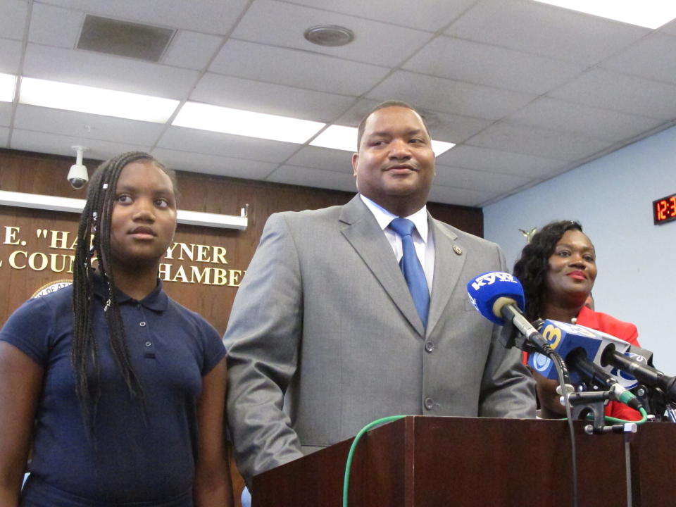 Marty Small, center, speaks at a swearing-in ceremony in Atlantic City, N.J. on Friday Oct. 4, 2019 after becoming the gambling resort's acting mayor. His predecessor, Frank Gilliam Jr., resigned a day earlier after pleading guilty to stealing $87,000 from a youth basketball team. With him are his daughter Jada, left, and his wife La'Quetta, right. (AP Photo/Wayne Parry)