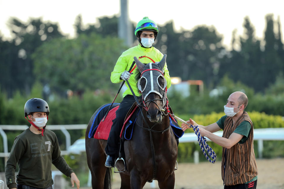 ISTANBUL, TURKEY - JUNE 08: A jockey rides a horse during a preparation practice for a race after restrictions gradually begin to be lifted in Istanbul, Turkey on June 08, 2020. The horse races postponed on 20 March and could not be held for 2.5 months with the decision of the Ministry of Agriculture and Forestry as part of coronavirus (COVID-19) measures to curb the spread of pandemic will restart tomorrow to be held at Veliefendi Hippodrome in Istanbul. Turkey's normalization process has started Monday (June 1) as the government decided to ease restrictions related to the novel coronavirus (COVID-19), considering the countryâs advances in fighting the pandemic. (Photo by Erhan Sevenler/Anadolu Agency via Getty Images)