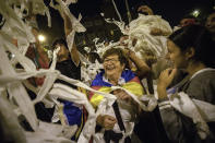 Catalan pro-independence demonstrators throw toilet paper rolls into the air during a protest in Barcelona Spain, Wednesday, Oct. 16, 2019. The Supreme Court found nine of 12 Catalan politicians and activists guilty of sedition and gave them prison sentences of nine to 13 years. Four of them were additionally convicted of misuse of public funds. The other three were fined for disobedience. (AP Photo/Bernat Armangue)