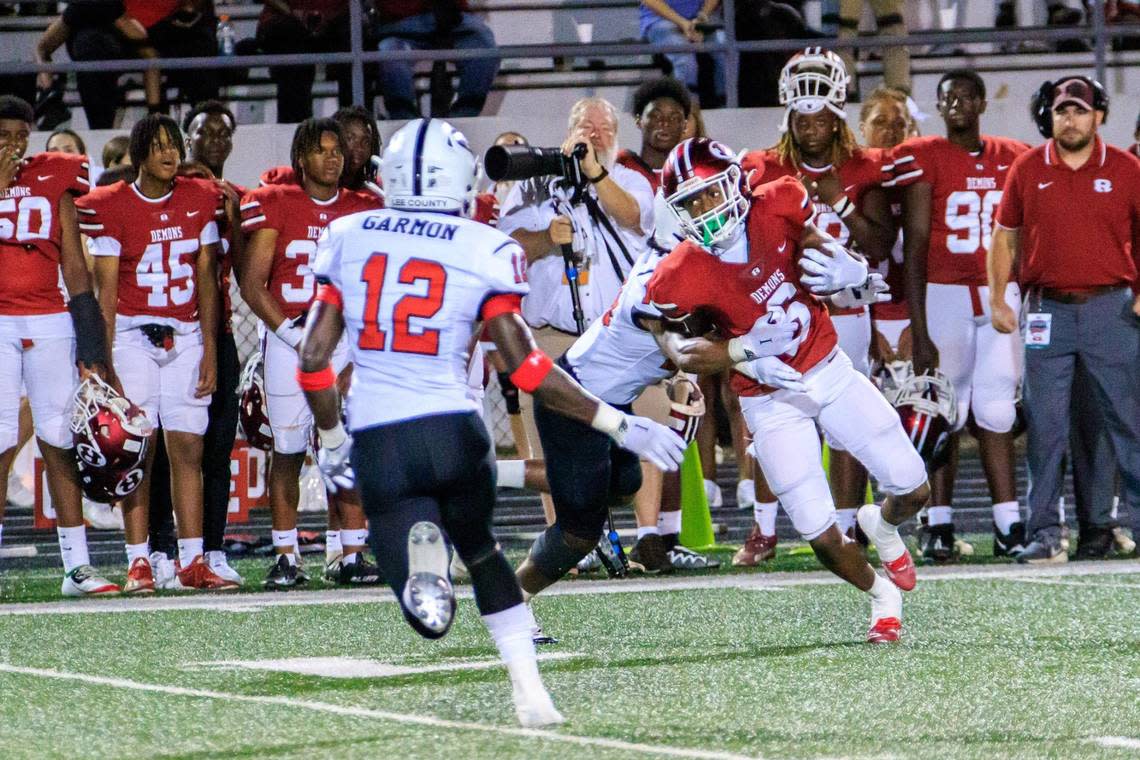 CLAY TEAGUE/FOR THE TELEGRAPH Warner Robins, GA, 8/19/22 Warner Robins’s Cam Flowers breaks a tackle on his way to score on a 50 yard touchdown pass from quarterback Chase Reese against Lee County. Clay Teague/For The Telegraph