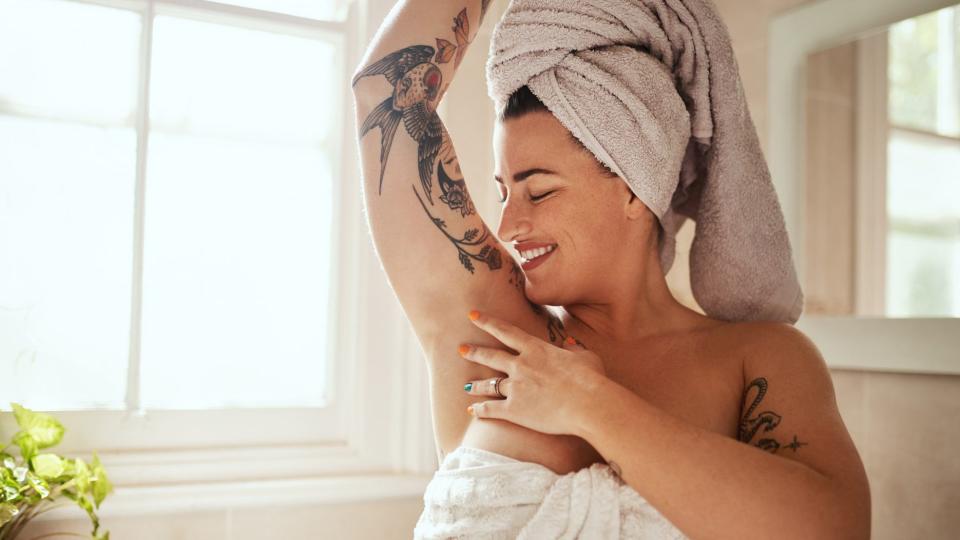 Woman_In_Towel_Smiling_Down_At_Her_Armpit