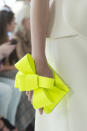 <p><i>Bright-yellow-green bow hand clutch from the SS18 Delpozo collection. (Photo: ImaxTree) </i></p>