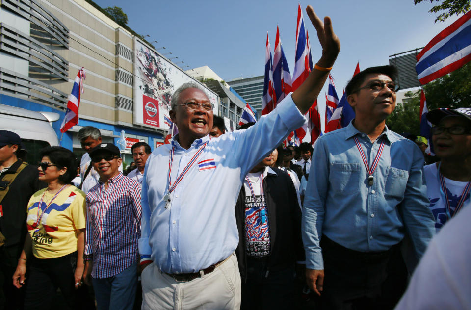 Anti-government protest leader Suthep Thaugsuban waves to supporters as he leads the last march from the main protest stage before it is removed from a popular intersection in Bangkok, Thailand, Sunday, March 2, 2014. The anti-government protesters withdrew from several stages erected at key intersections around Bangkok. Starting Monday, they will consolidate at Lumpini Park, a central venue that has become a traditional protest site. (AP Photo/Wally Santana)