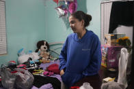 Melanie Rolo Gonzalez stands in the bedroom she will be sharing with her 1-year-old daughter, Madisson, and sister Merlyn at the home of a family friend in Daytona, Florida, Tuesday, Jan. 3, 2023. The three arrived in the U.S. after a three-week journey through Central America and Mexico. Over the past two years, American authorities have detained Cubans nearly 300,000 times on the border with Mexico. Some of the Cubans have been sent home, but the vast majority have stayed under immigration rules dating to the Cold War. (AP Photo/Marta Lavandier)