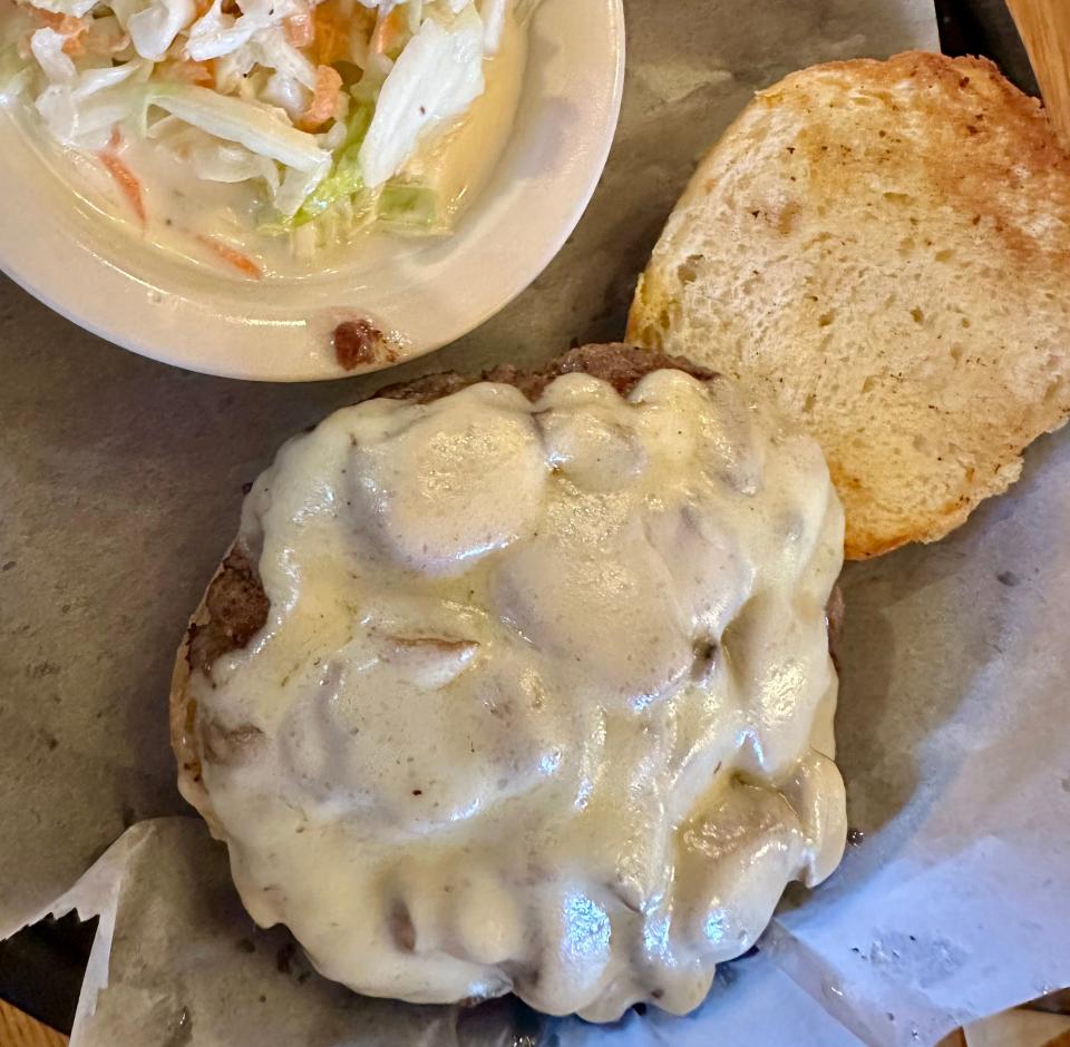 The Joey Burger, complete with two cheeses, mushrooms and onions, comes with a side of coleslaw and fries at Joey's Kendal Tavern in Massillon.