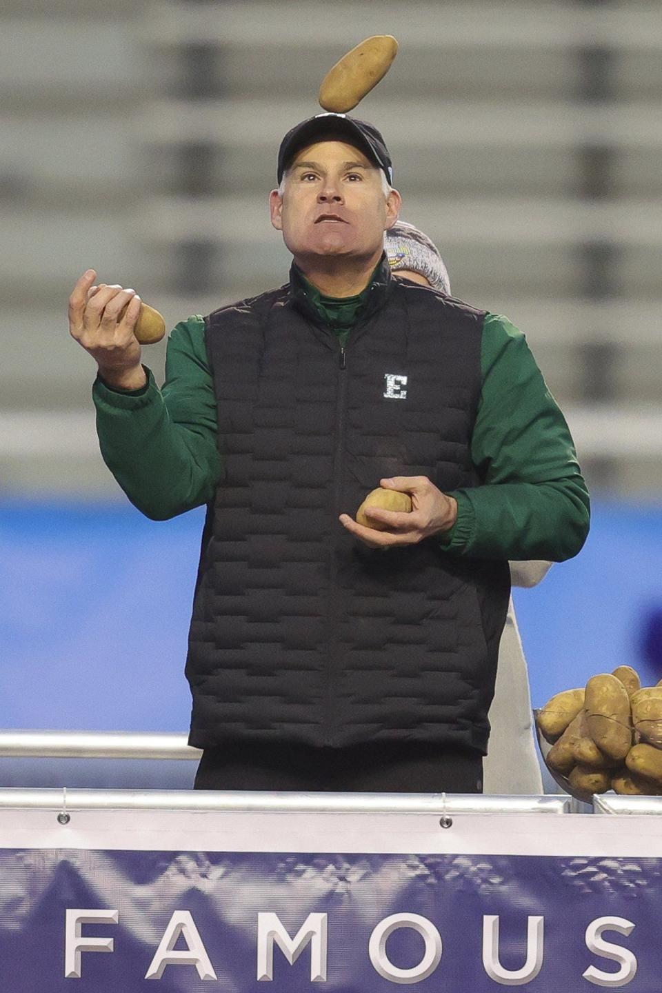 Eastern Michigan coach Chris Creighton juggles potatoes from the Idaho Potato Bowl trophy after the 41-27 win over San Jose State in the Famous Idaho Potato Bowl on Tuesday, Dec. 20, 2022, in Boise, Idaho.