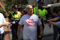 <p>A man with the “Boston Free Speech” rally is escorted by the Boston Police Department from Park Square on the Boston Common in Boston, Aug. 19, 2017. (Photo: John Tlumacki/The Boston Globe via Getty Images) </p>