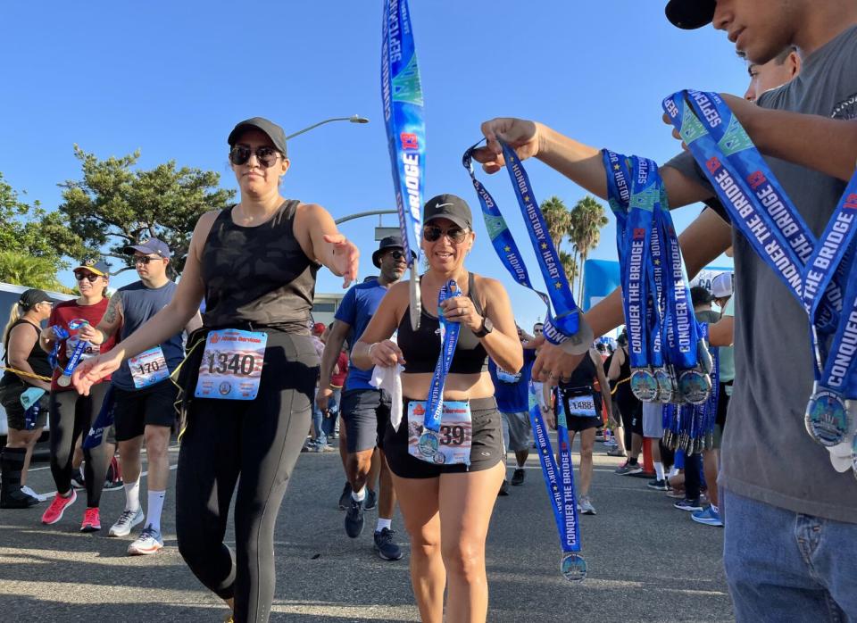 Runners complete a race and receive medals