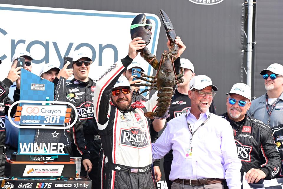 July 17: Martin Truex Jr. hoists the 22-pound lobster awarded to the winner of the Crayon 301 at New Hampshire Motor Speedway.
