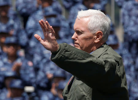 U.S. Vice President Mike Pence waves to U.S. and Japanese service members on the flight deck of the USS Ronald Reagan, a Nimitz-class nuclear-powered super carrier, at the U.S. naval base in Yokosuka, south of Tokyo, Japan April 19, 2017. REUTERS/Kim Kyung-Hoon