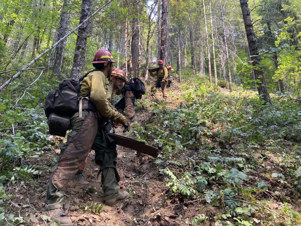 Crews work on steep terrain as they fight the Ore Fire.