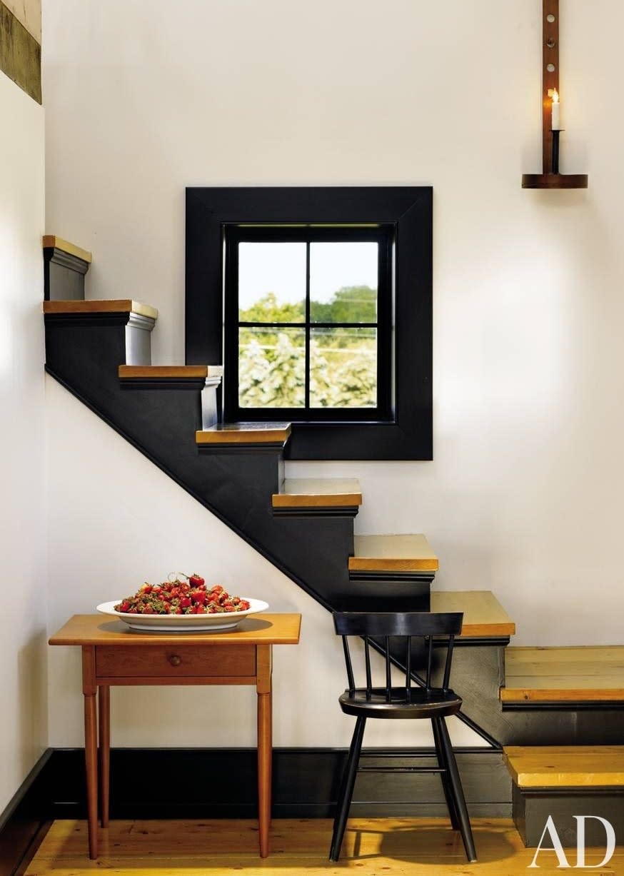 Baseboads and a wide window frame, in dark paint, keep this minimalist, Shaker-inspired space by Mark Manardo and Barbara Balow from feeling sparse.