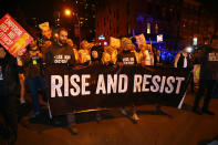 <p>A group of people carry a “Rise and Resist” banner at the 44th annual Village Halloween Parade in New York City on Oct. 31, 2017. (Photo: Gordon Donovan/Yahoo News) </p>