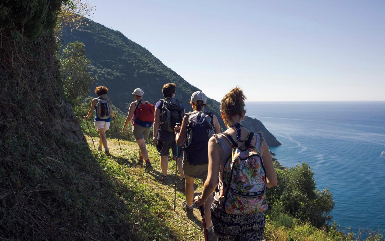 Walkers are only allowed to travel in one direction along the narrow paths that link the villages of the Cinque Terre in Liguria, Italy