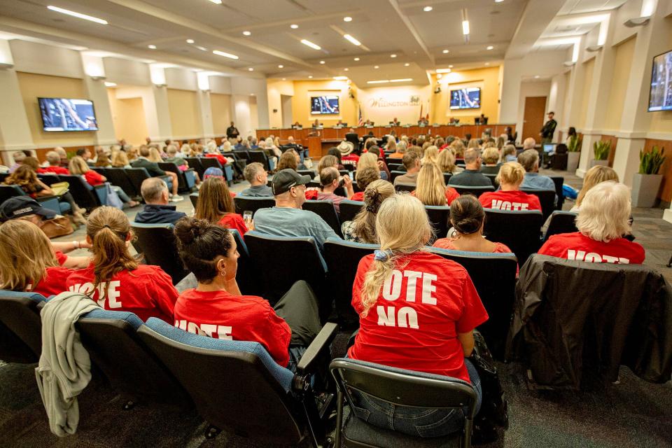 Wellington residents some wearing vote no red t-shirts, attend a Village of Wellington Council meeting November 14, 2023, to address amendments to the Equestrian Village.