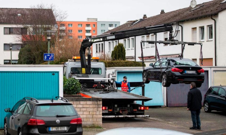 The car believed to belong to the suspect is removed from near his home.