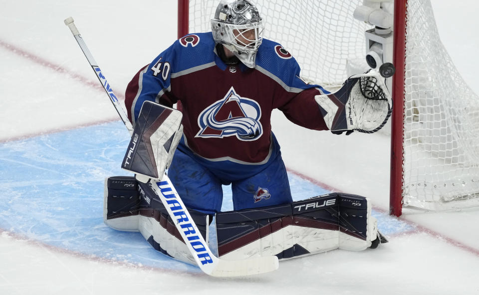 Colorado Avalanche goaltender Alexandar Georgiev deflects a shot during the first period of the team's NHL hockey game against the Vegas Golden Knights on Wednesday, Jan. 10, 2024, in Denver. (AP Photo/David Zalubowski)