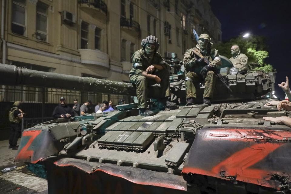 Membes of the Wagner Group military company sit atop of a tank on a street in Rostov-on-Don, Russia, Saturday, June 24, 2023, prior to leaving an area at the headquarters of the Southern Military District. Kremlin spokesman Dmitry Peskov said that Yevgeny Prigozhin's troops who joined him in the uprising will not face prosecution and those who did not will be offered contracts by the Defense Ministry. After the deal was reached Saturday, Prigozhin ordered his troops to halt their march on Moscow and retreat to field camps in Ukraine, where they have been fighting alongside Russian troops. (AP Photo)