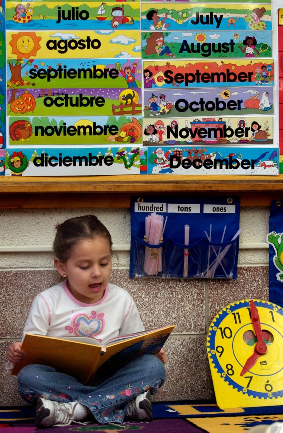 A girl reads a book in school in 2005