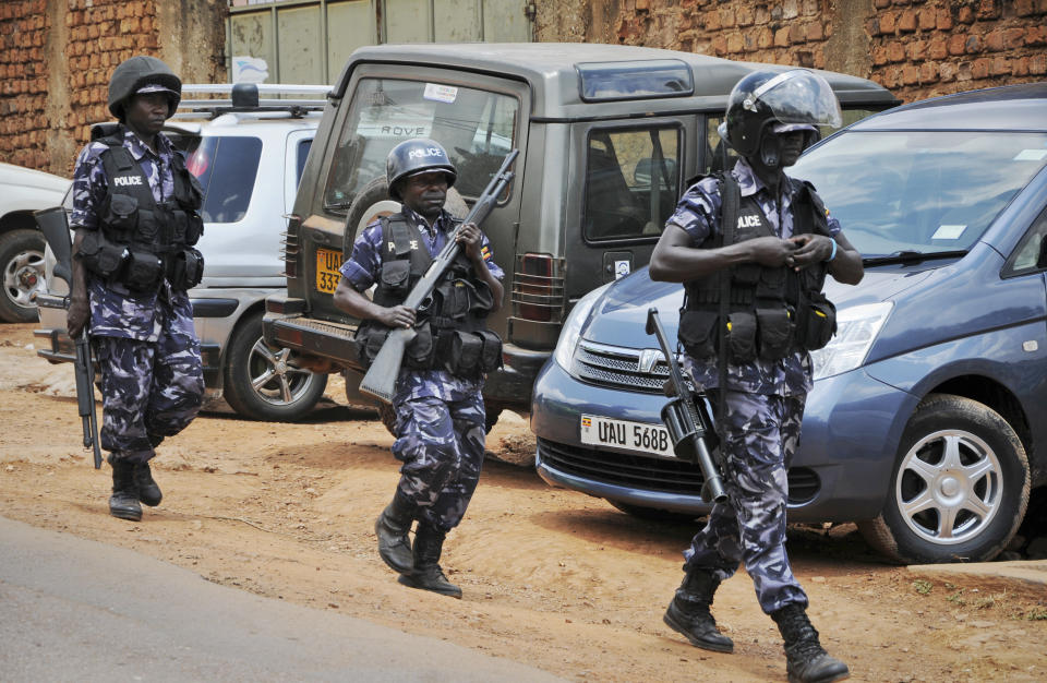 Ugandan riot police patrol on the streets of the Kamwokya neighborhood where pop star-turned-opposition lawmaker Bobi Wine, whose real name is Kyagulanyi Ssentamu, has his recording studio and many supporters, in Kampala, Uganda Thursday, Sept. 20, 2018. Security forces took Bobi Wine into custody when he arrived from the United States on Thursday, angering his supporters, while authorities barred public gatherings. (AP Photo/Ronald Kabuubi)