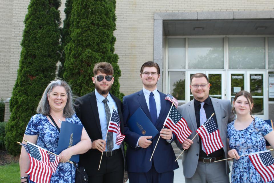 Lesley (left), Morgan (center), and Martyn (second right) Reed all took the Oath of Allegiance on Friday, May 3, officially becoming U.S. citizens.