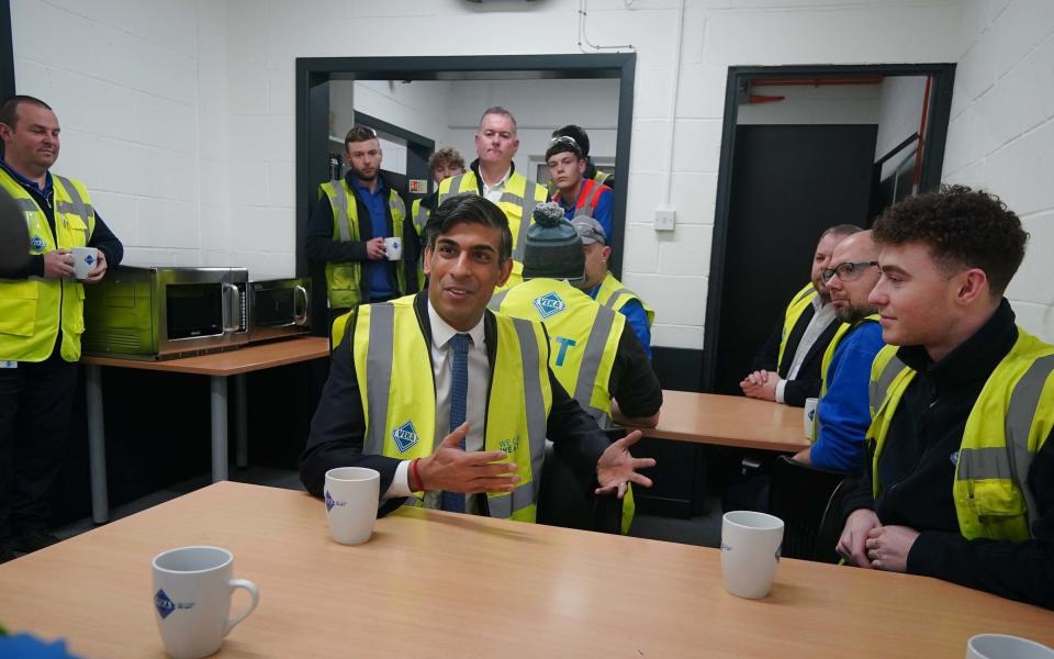 Prime Minister Rishi Sunak (centre) speaking to staff during a visit to VEKA PLC in Burnley, Lancashire